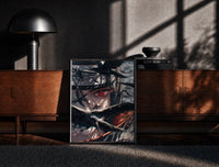 Black-framed Anime ninja with Sharingan eye print on a moody console with designer coffee-table books