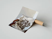 Gently curled It's a Beautiful Day to Be Black print beside its protective shipping tube