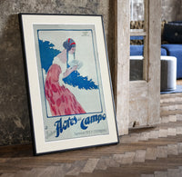 Woman holding soap box print in a black frame leaning beside a vintage door on parquet