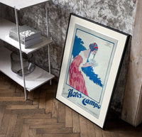 Woman holding soap box poster in a black frame leaning beside a shelf in a raw-plaster loft