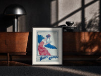 Black-framed Woman holding soap box print on a moody console with designer coffee-table books