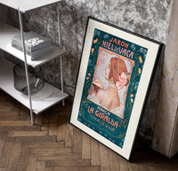 Art Nouveau woman in profile poster in a black frame leaning beside a shelf in a raw-plaster loft