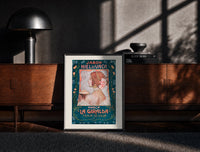 Black-framed Art Nouveau woman in profile print on a moody console with designer coffee-table books