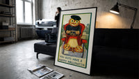 Pumpkin-headed man driving red car print in a slim black frame leaning on a dark sofa in a concrete print studio