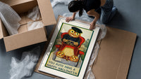 Pumpkin-headed man driving red car framed print being unpacked from protective bubble wrap and a box