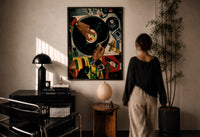 Jeweled Hands on a Turntable print in a black frame on a sunlit plaster wall, a woman looking on beside a mushroom lamp