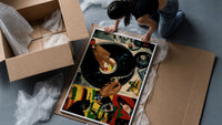 Jeweled Hands on a Turntable framed print being unpacked from protective bubble wrap and a box