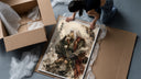 White-haired ninja sitting thoughtfully framed print being unpacked from protective bubble wrap and a box