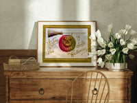 Carved jack-o-lantern hanging on broom print in an oak frame on a farmhouse dresser beside white tulips