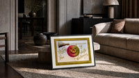 Carved jack-o-lantern hanging on broom print in a slim black frame leaning on a travertine coffee table