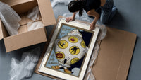 Vintage Halloween clown holding sheet framed print being unpacked from protective bubble wrap and a box