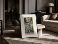 Angel blowing trumpet over rising figures print in a black frame leaning on a travertine table in a sunlit lounge