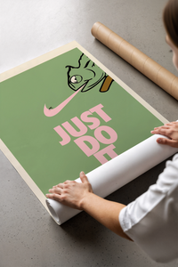 Unrolling the green chameleon print with pink swoosh across a bare concrete studio floor