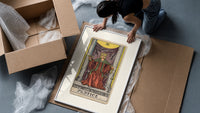 Justice tarot card figure framed print being unpacked from protective bubble wrap and a box