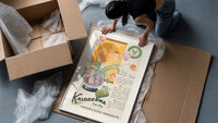 Woman smelling tulips in vase framed print being unpacked from protective bubble wrap and a box