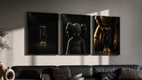 KAWS Companion Matte Black and Gold Set of 3 in black frames on a grey wall above a leather sofa