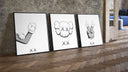 KAWS cartoon hands and skull face three-piece set leaning on parquet beside a vintage loft door