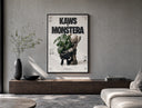 KAWS Companion figure holding monstera plant poster framed above a wood console in a concrete-wall living room