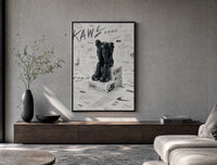 KAWS Companion figure sitting poster framed above a wood console in a concrete-wall living room