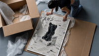 KAWS Companion figure sitting framed print being unpacked from protective bubble wrap and a box