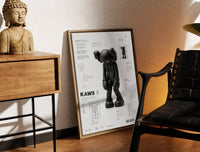 Brass-framed KAWS Companion Passing Through figure print leaning in a warm styled corner by a sculpture