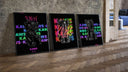 Black KAWS Companion figures triptych three-piece set leaning on parquet beside a vintage loft door