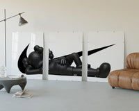 Triptych of the Black stylized figure lying down with crossed eyes displayed above a couch