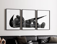 Black stylized figure lying down with crossed eyes three-panel set styled in a living room