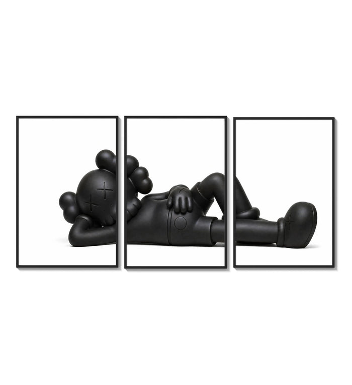 Black stylized cartoon character figures in reclined poses three-panel set arranged on a gallery wall