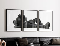 Black stylized cartoon character figures in reclined poses three-panel set styled in a living room