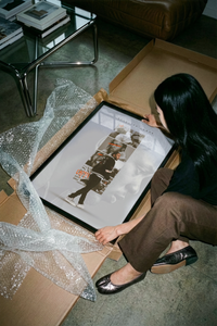 Kendrick Lamar DAMN monochrome photography print displayed next to a brown cardboard mailing tube