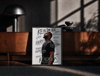 Black-framed Man looking upward in profile print on a moody console with designer coffee-table books