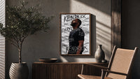 Man looking upward in profile poster framed above a fluted sideboard beside an olive tree
