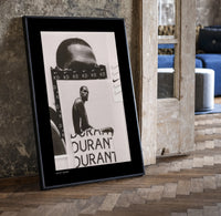 Kevin Durant basketball player portrait print in a black frame leaning beside a vintage door on parquet