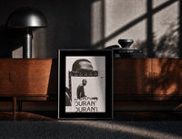 Black-framed Kevin Durant basketball player portrait print on a moody console with designer coffee-table books