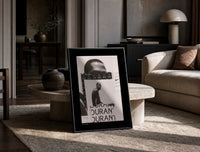 Kevin Durant basketball player portrait print in a black frame leaning on a travertine table in a sunlit lounge