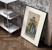 King of Cups tarot figure poster in a black frame leaning beside a shelf in a raw-plaster loft