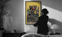 King of Pentacles print in a slim black frame being hung on a sunlit wall in a monochrome room