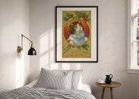 Kitten Wishing You a Merry Christmas print in a black frame above a bed with striped linens