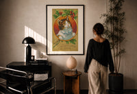 Kitten Wishing You a Merry Christmas print in a black frame on a sunlit wall with a viewer