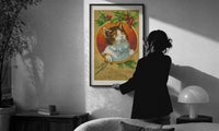 Kitten Wishing You a Merry Christmas print in a slim black frame being hung on a sunlit wall in a monochrome room