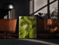 Black-framed Kiwi Fruit Slices print on the floor in front of a dark wooden console