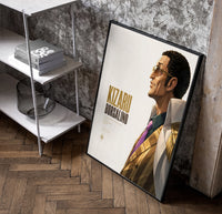 Man in profile with sunglasses poster in a black frame leaning beside a shelf in a raw-plaster loft
