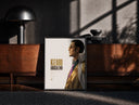 Black-framed Man in profile with sunglasses print on a moody console with designer coffee-table books