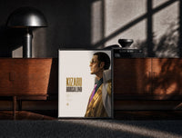 Black-framed Man in profile with sunglasses print on a moody console with designer coffee-table books