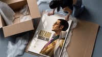 Man in profile with sunglasses framed print being unpacked from protective bubble wrap and a box