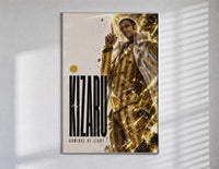 Man in gold striped suit pointing up poster in a slim frame on a bright wall with soft window light