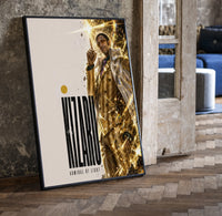 Man in gold striped suit pointing up print in a black frame leaning beside a vintage door on parquet