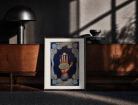 Black-framed Upraised hand with alchemical symbols print on a moody console with designer coffee-table books