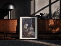 Black-framed Old alchemist reading book with flask print on a moody console with designer coffee-table books